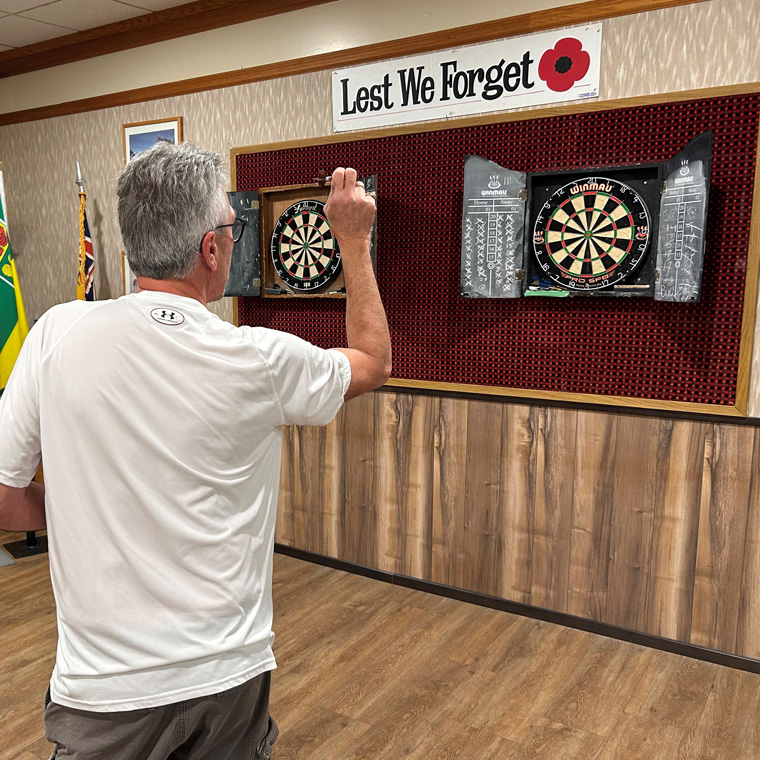 An Image of someone playing darts