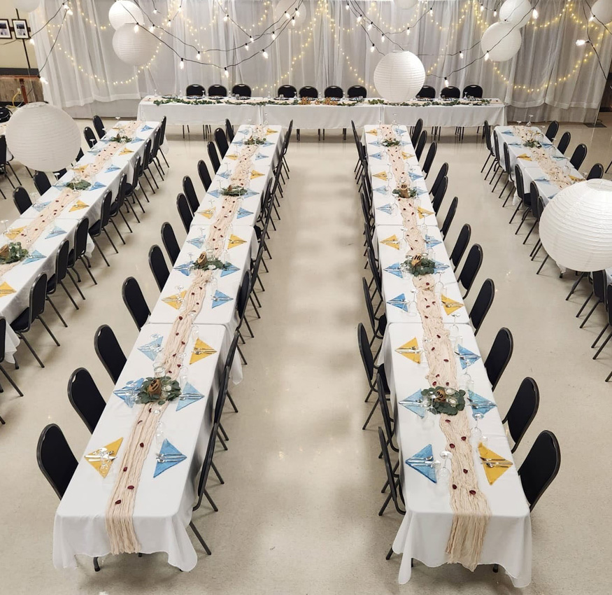 Image of the Legion Hall set up for a wedding with a head table and all the place settings