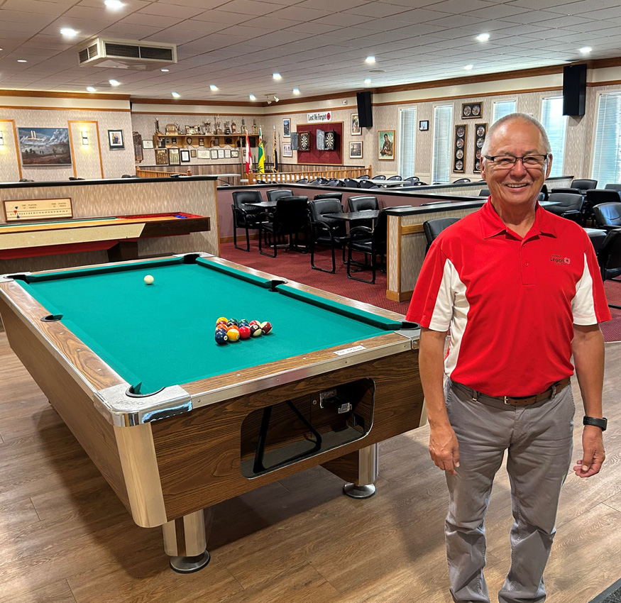 Image of a Legion Volunteer standing in front of a pool table om the Legion Hall Club Room